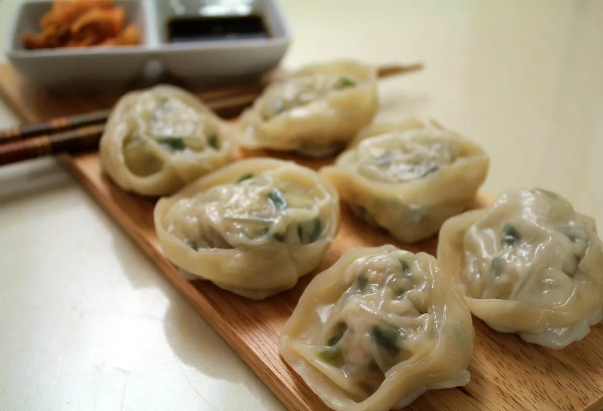 Steamed Korean dumplings on a wooden board